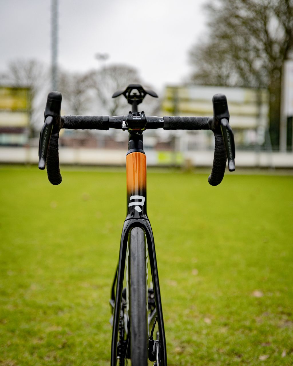 road bike, drop bars, orange stem, carbon fork, front view