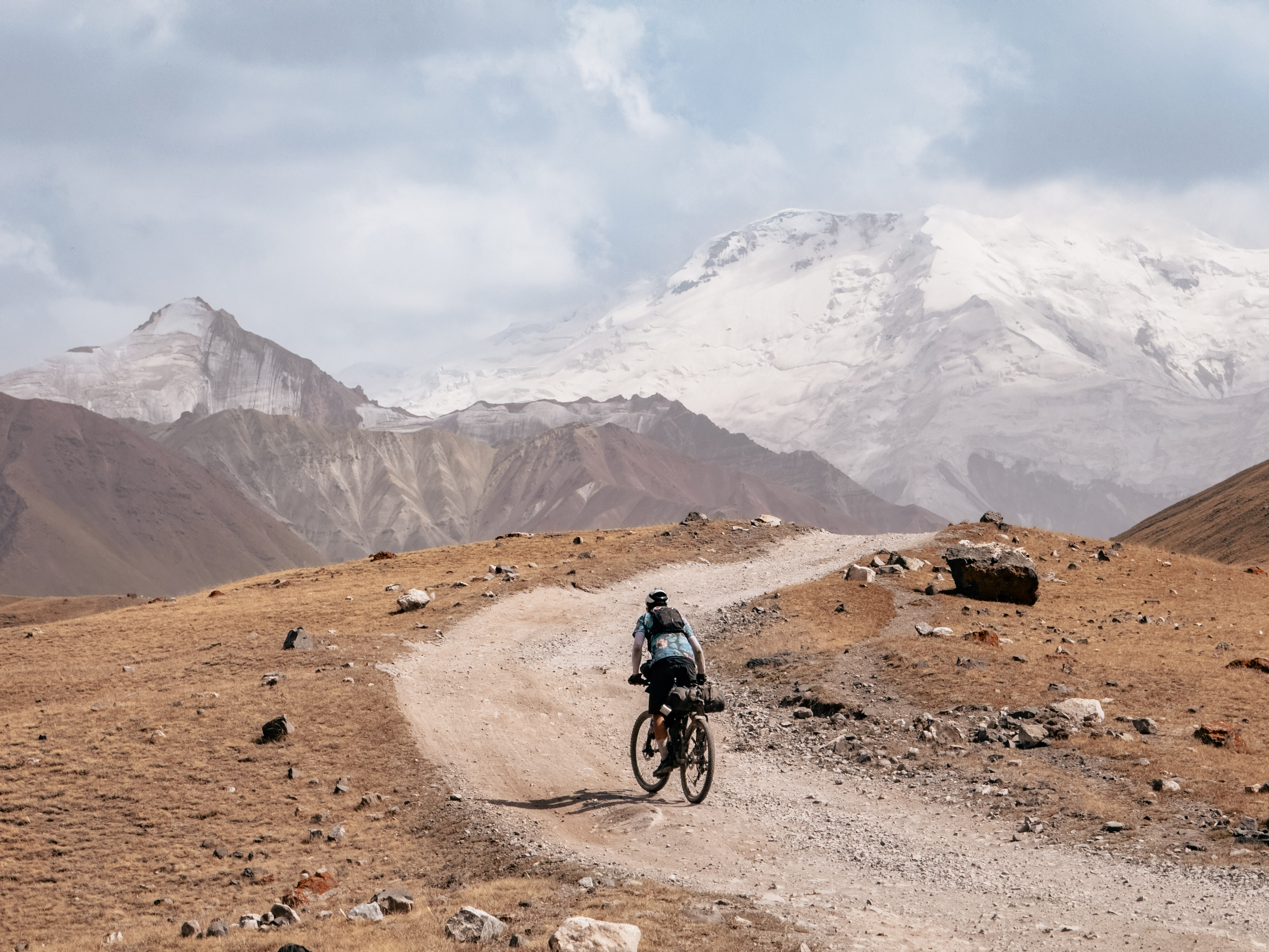 Mountain bike, Bike on trail, Rugged landscape, Snowy mountains, Desert path